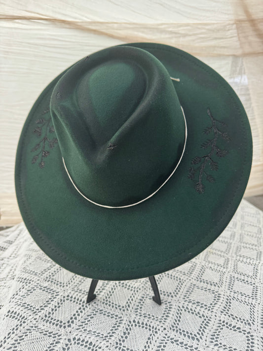 Dark green hat with floral burned detail